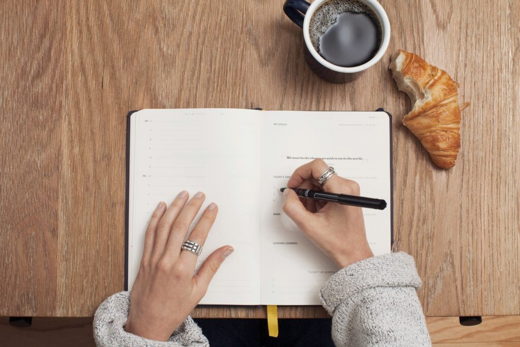 A person writing on a notebook