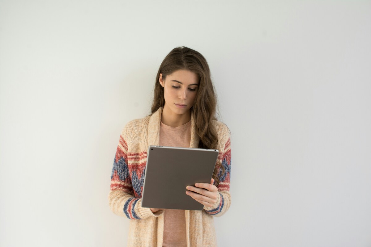 A woman holding a tablet for neuropsychological evaluation