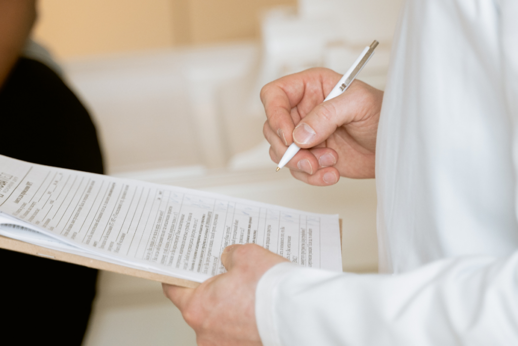 Doctor holding a paper with an assessment form
