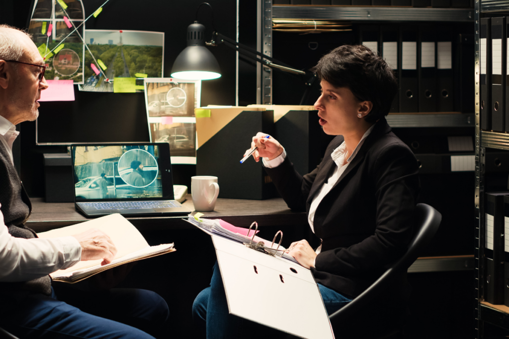 Forensic Psychologist discussing with an elderly man, holding a notebook
