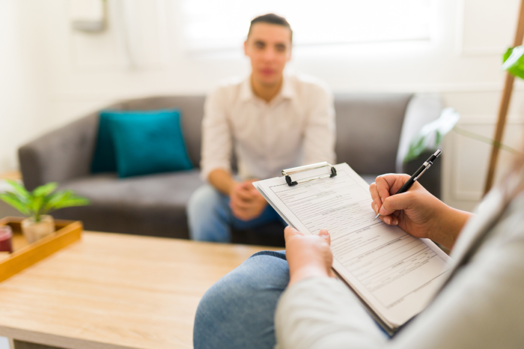 Psychologist talking to a client while holding a form
