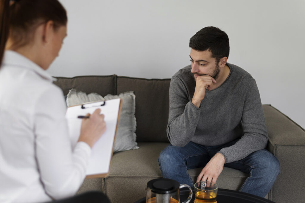 A man consulting a therapist