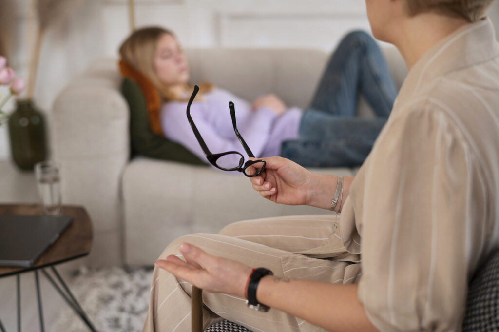 A woman holding eyeglasses