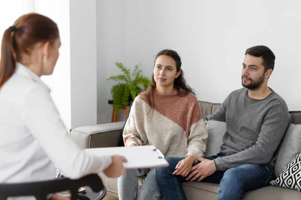 A man supporting his wife during therapy.