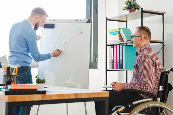 A person helping a person with disabilities