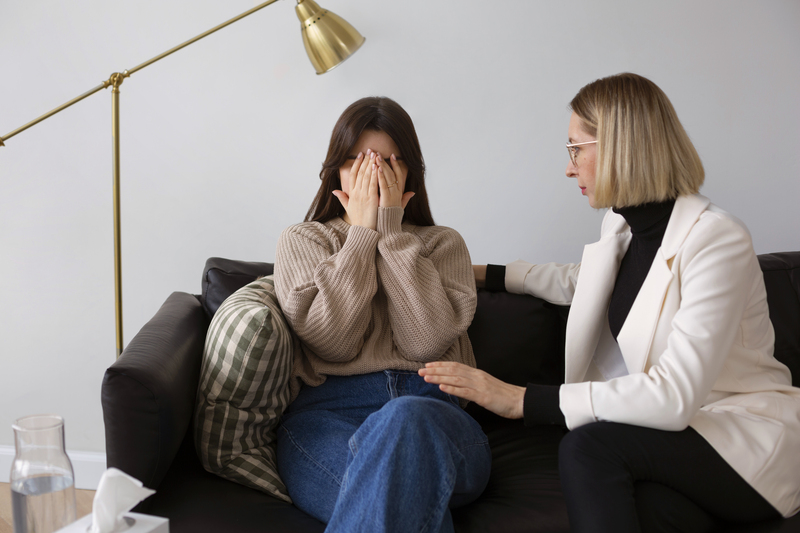 A trauma therapist consoling the young woman.