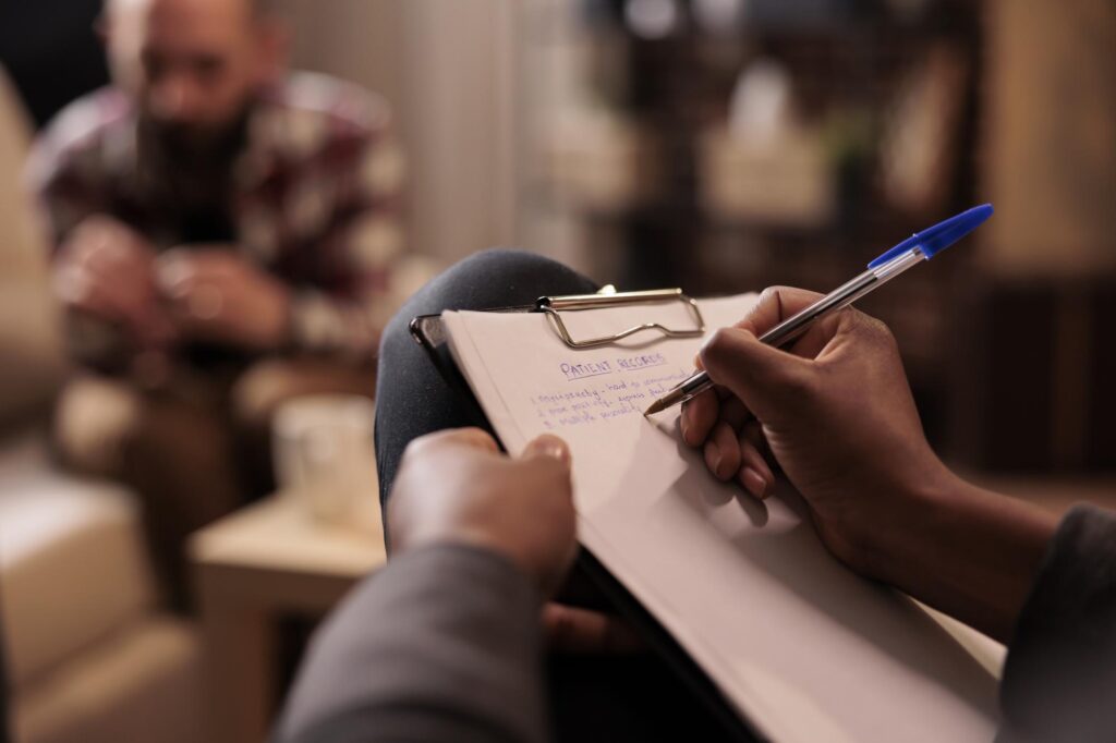 A psychologist updating the patients records