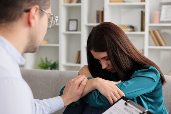 A woman with anxiety being comforted by the psychologist