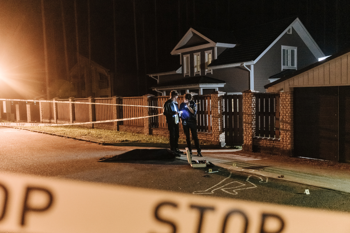 Two forensic psychologists examining evidence at a crime scene