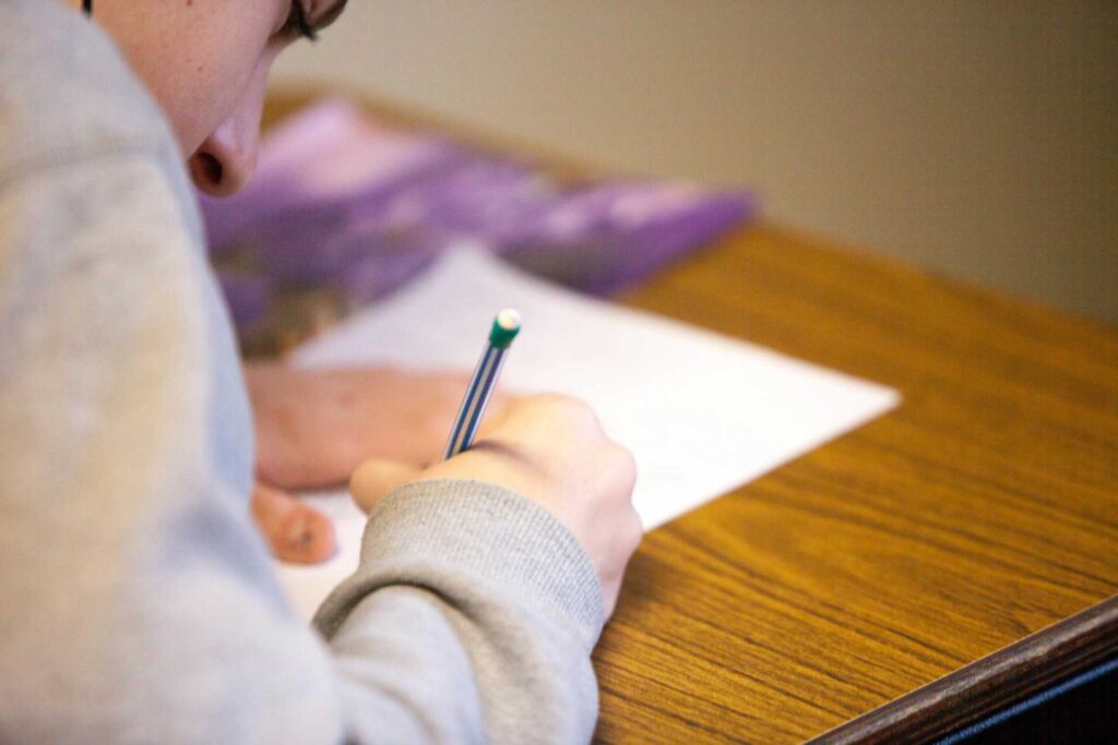 A person writing on a paper