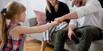 a father bumping fist with daughter before family therapy